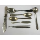 Three silver spoons together with a silver butter knife, berry spoons and two nut picks
