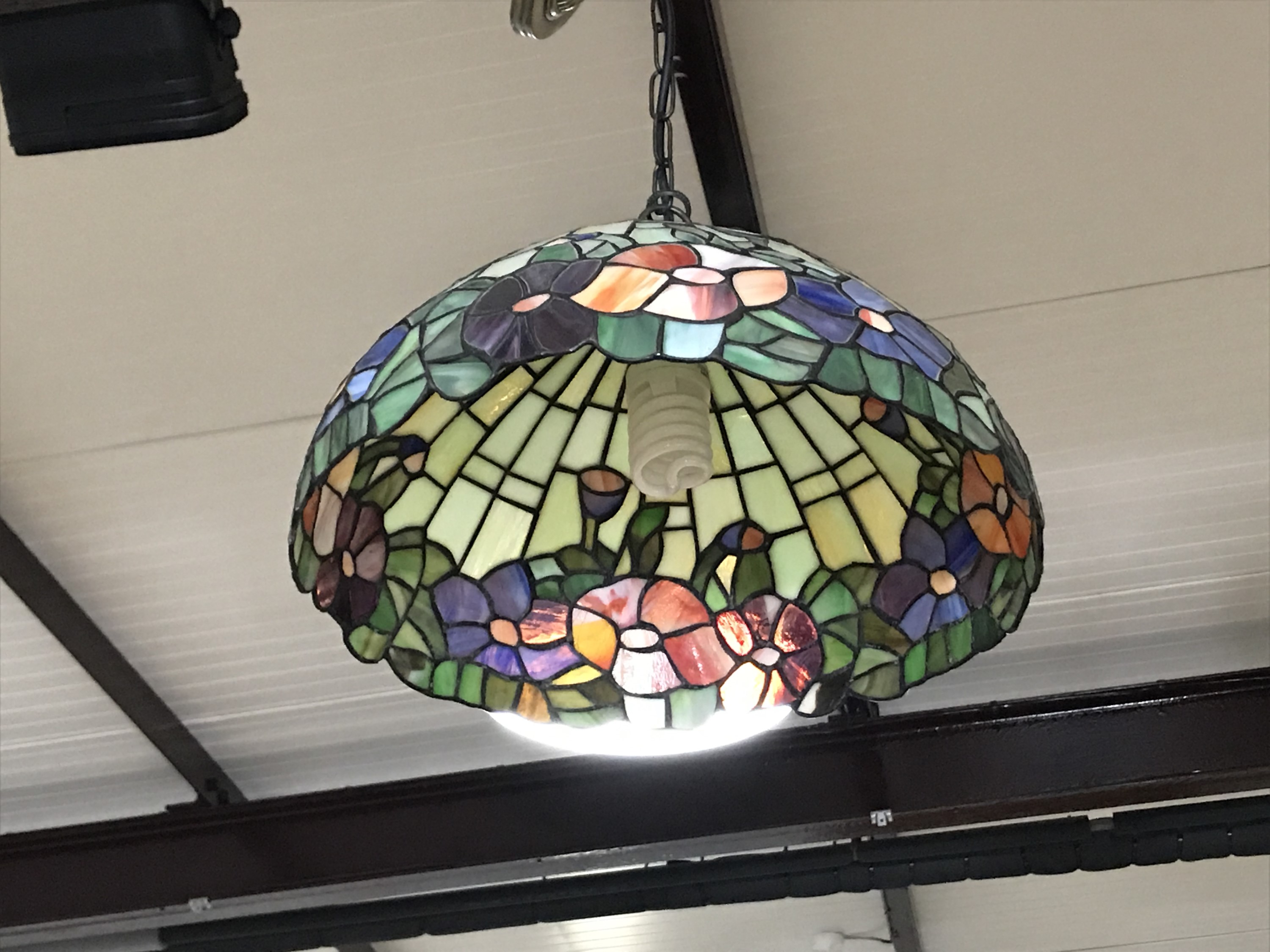 A pair of Tiffany style leaded and stained glass pendant ceiling lights, 43 cm diameter