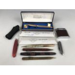 A Magna cigarette lighter together with two pen knives and propelling pencils etc