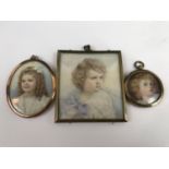 Three Edwardian period portrait miniatures of children, one young girl having golden brown