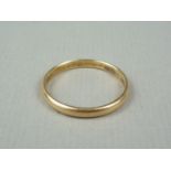 A late 19th / early 20th Century high carat yellow metal wedding band, stamped 18ct, tests as