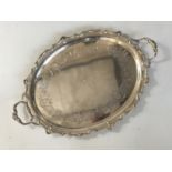 A George VI silver two-handled oval tray, having elaborately moulded and shaped rim, and bearing