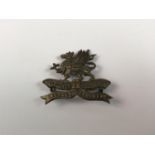 An Eleventh (Lonsdale) Battalion Border Regiment brass cap badge