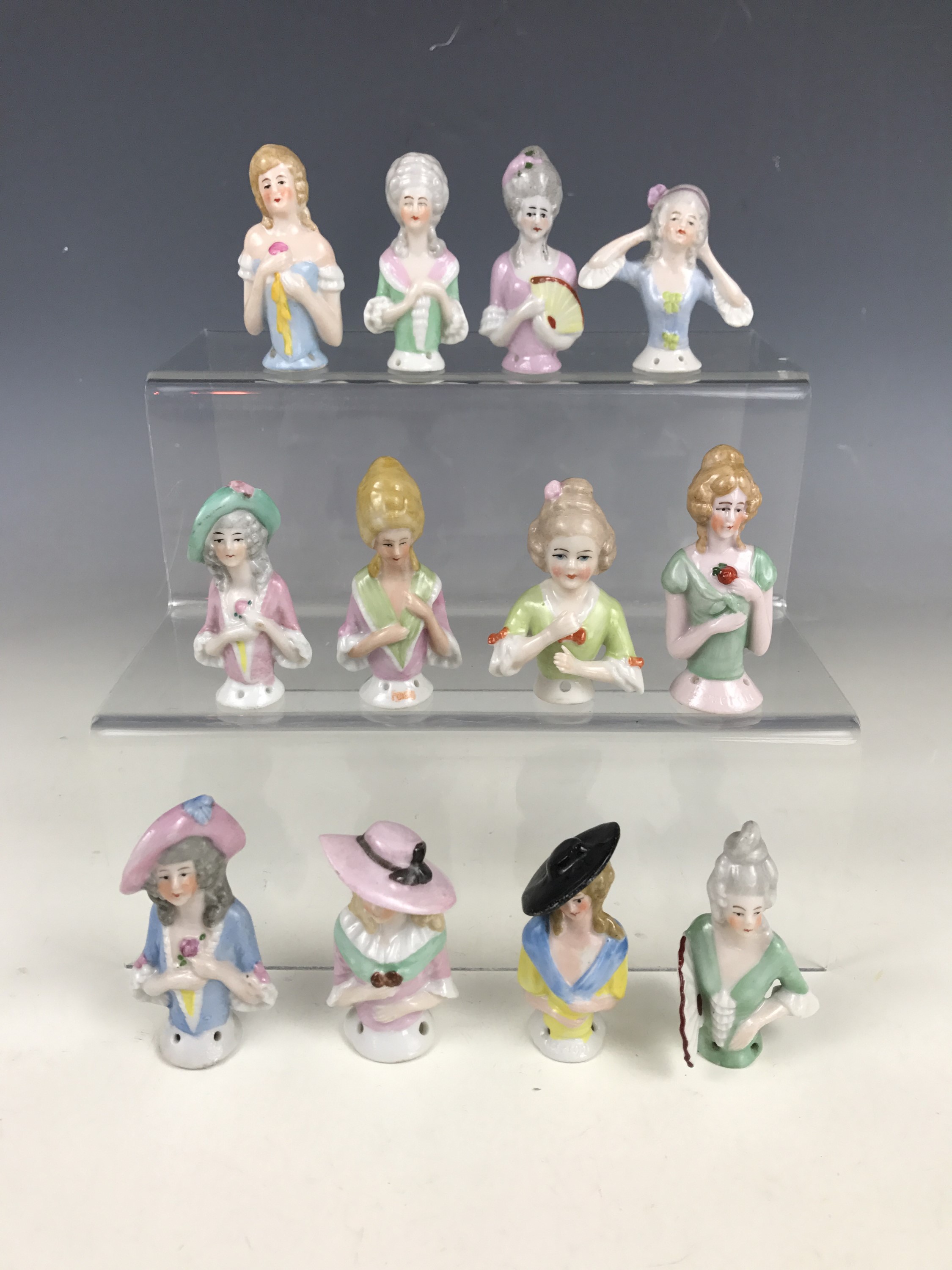 Twelve vintage continental porcelain pin-cushion ladies wearing 18th Century fashion and powdered