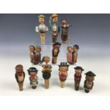 A collection of vintage Black Forest type novelty automaton and other bottle stoppers