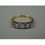 An early 20th Century five stone diamond ring, sunken and claw set in a graded arrangement, the
