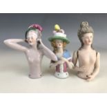 Three uncommonly large vintage continental porcelain pin-cushion ladies, one bisque porcelain