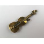 A novelty brass strike-a-light in the form of a violin, 16.5 cm