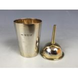 A Victorian silver spirit / perfume funnel and beaker, retailed by Finnigans of Manchester, parcel