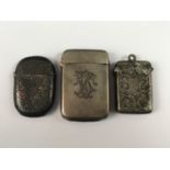 Three silver vesta cases, one engraved with a monogram, George Unite, Birmingham, 1886, together