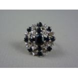 A flamboyant sapphire and diamond dress ring, the brilliants set in terraces, the circular