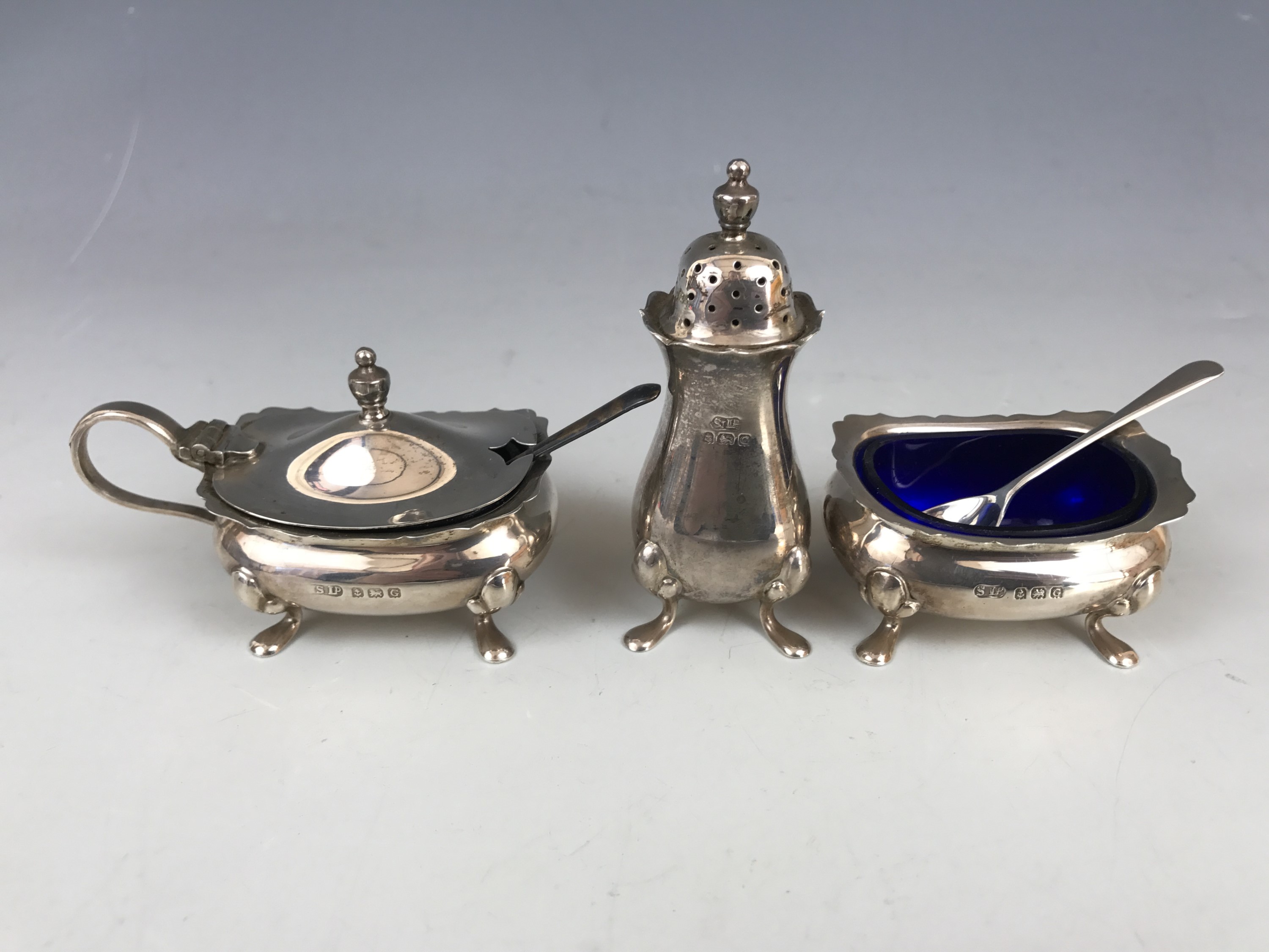 A George V silver cruet set, comprising pepperette, mustard and salt, William Suckling Ltd,