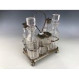 A Victorian silver mounted and cut glass cruet set and stand, Henry Manton, Birmingham, 1881 (a/f