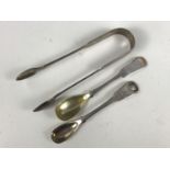 A pair of Victorian silver sugar tongs, Chawner & Co, London, 1863, together with two Georgian