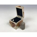 A 19th Century mother-of-pearl and tortoiseshell veneered thimble case and later silver thimble