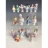 Fifteen vintage continental porcelain pin-cushion ladies modelled as flappers or 'bright young