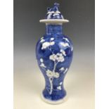 A Chinese Qing period porcelain covered vase, decorated in the prunus pattern, painted character