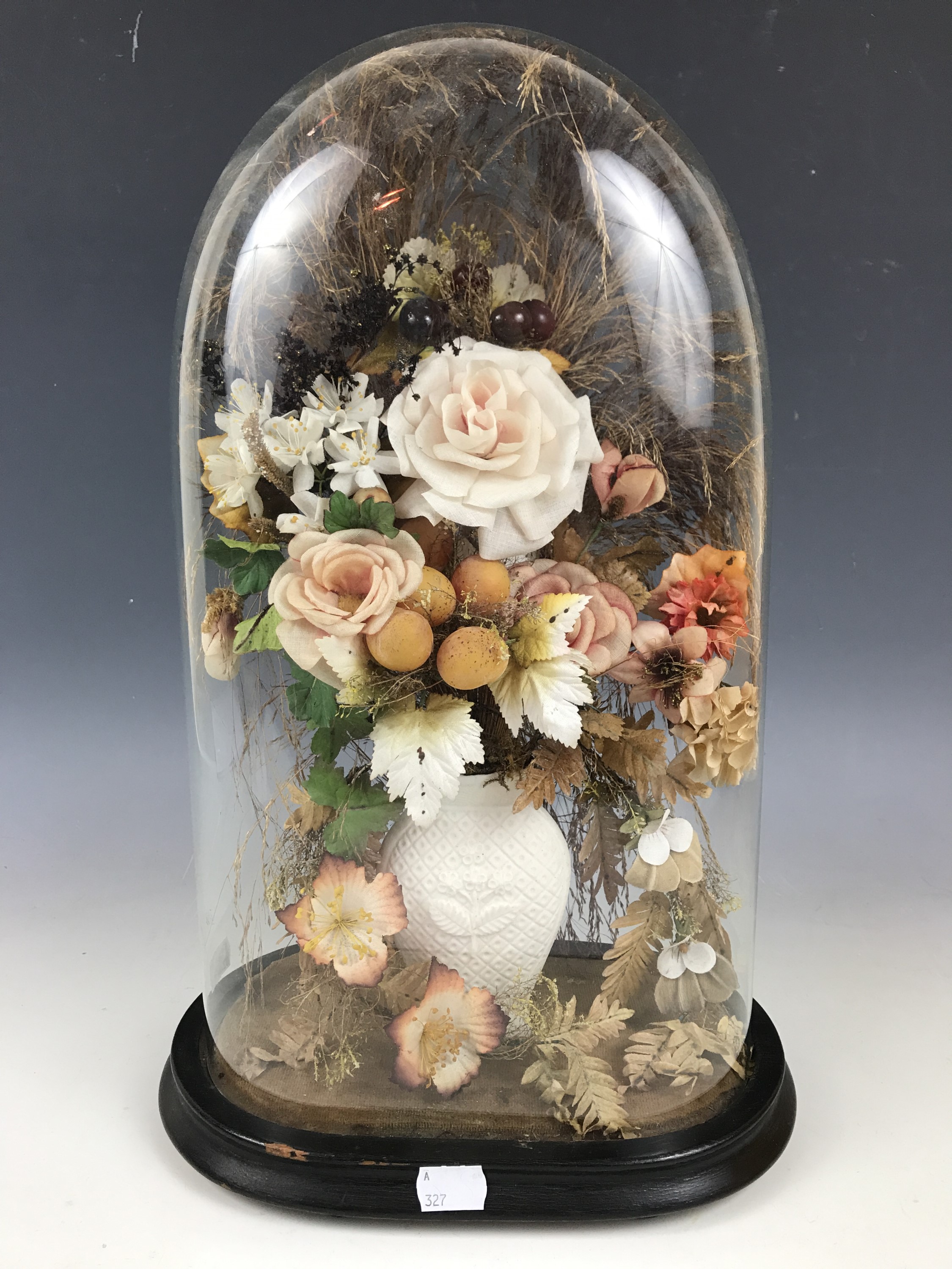 A Victorian display of perpetual flowers under a glass dome, 31 cm