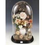 A Victorian display of perpetual flowers under a glass dome, 31 cm