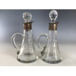 A pair of Edwardian silver mounted cut glass noggins or cruets, J. H. Worrall, Son & Co Ltd,