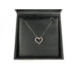 A contemporary 9ct white gold and diamond heart shaped pendant necklace, retailed by Ernest Jones,