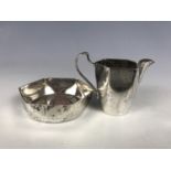 A German miniature white metal sugar bowl and cream jug, each of hexagonal section and pinched