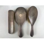 An Edwardian silver dressing table mirror and brush set, comprising hand mirror, hair brush and