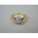 A vintage diamond cluster cocktail ring, with central brilliant cut stone of approximately .05ct,