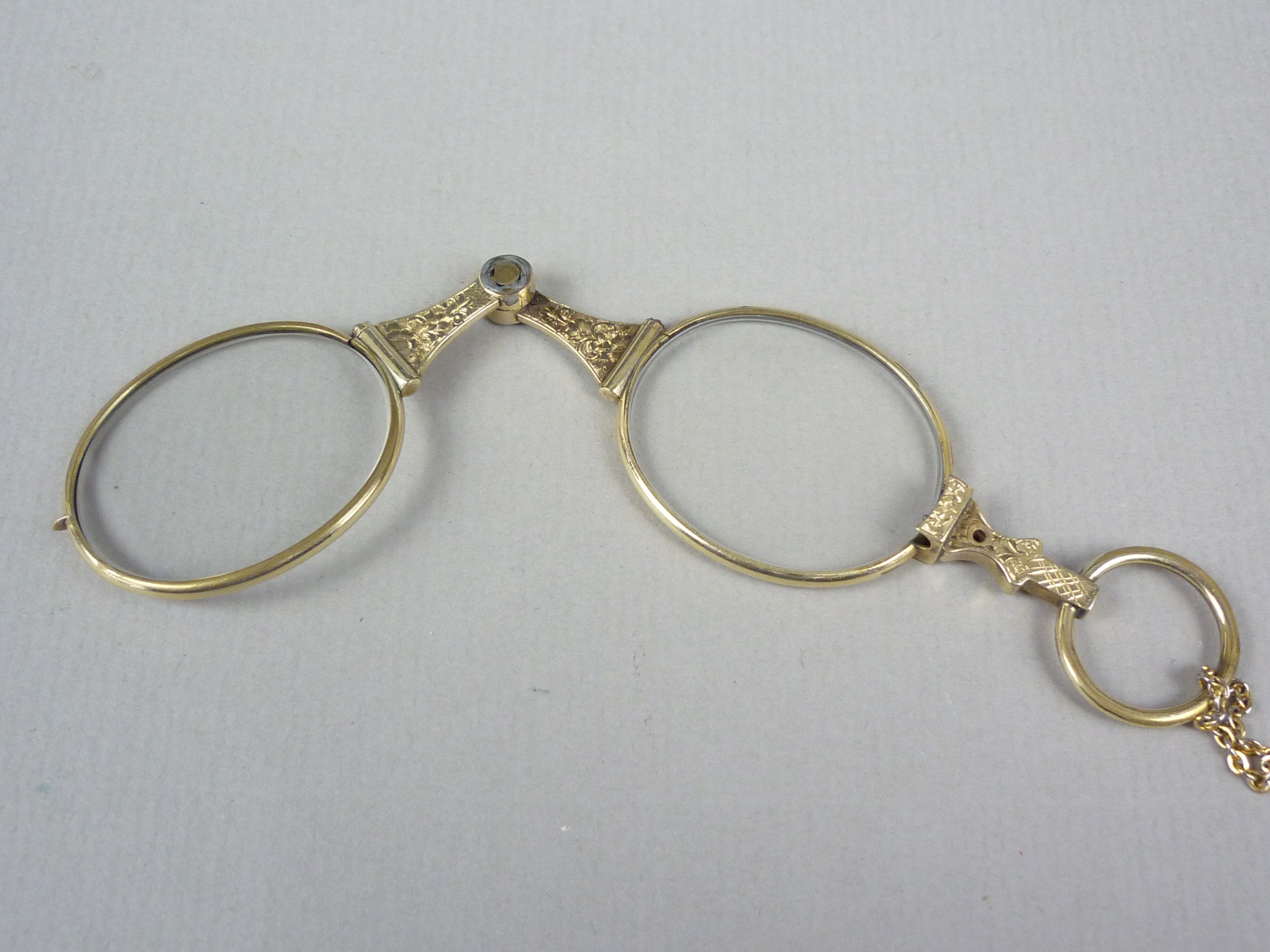 An early 20th Century rolled gold lorgnette, with engraved decoration, on a rolled-gold neck chain - Image 2 of 2