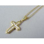 A diamond and 18ct gold cruciform pendant necklace, the captive brilliant-cut diamonds being channel