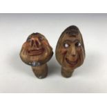 Two early 20th Century novelty carved Tagua nut bottle stoppers, each modelled as the head of a
