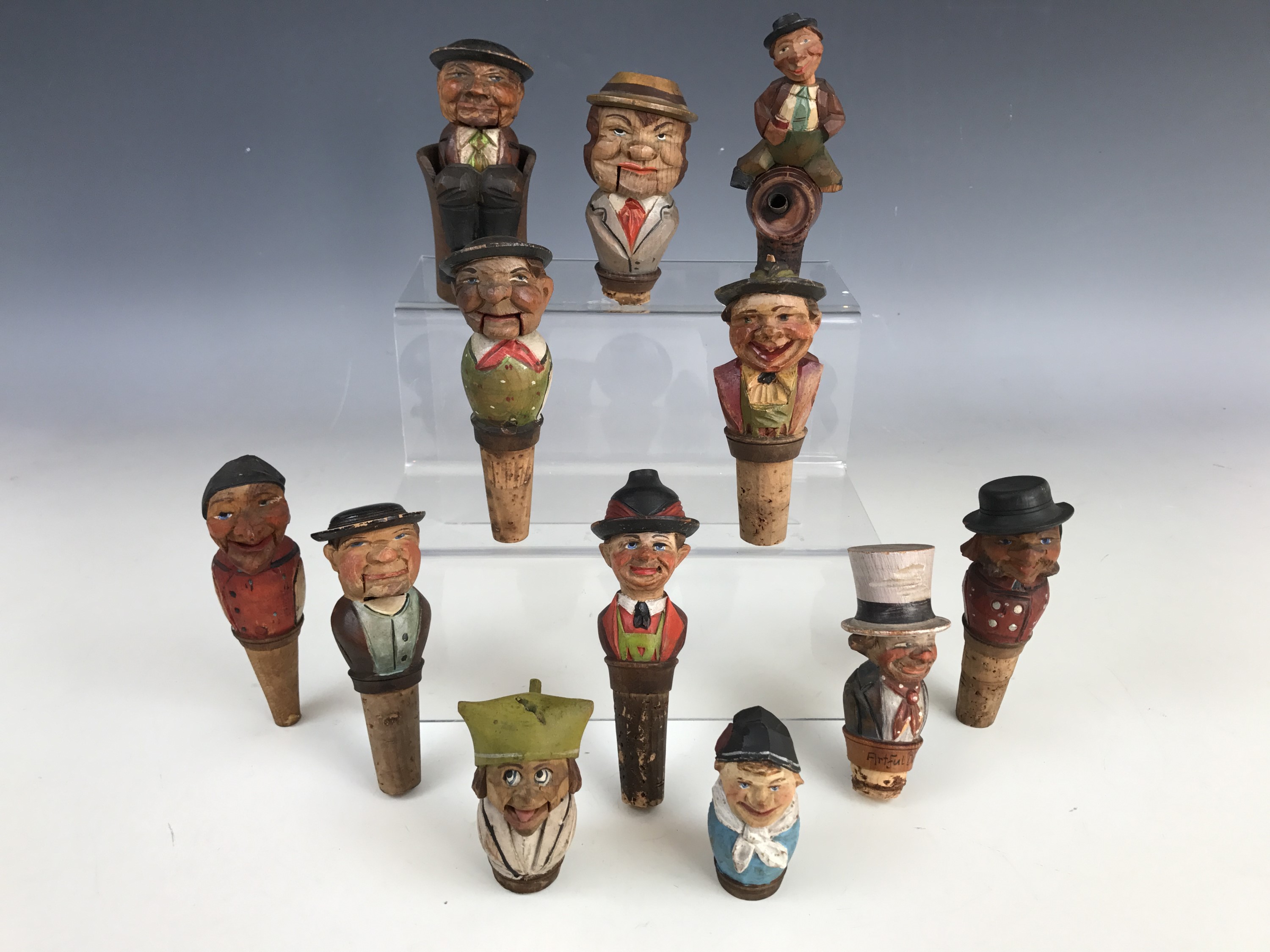 A collection of vintage Black Forest type novelty automaton and other bottle stoppers