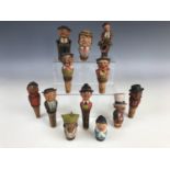 A collection of vintage Black Forest type novelty automaton and other bottle stoppers