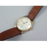 A 1950s 9ct gold Cyma wrist watch, having a calibre R.458 17 jewel movement, brushed silver circular