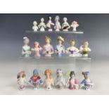 Eighteen vintage miniature continental porcelain pin-cushion ladies wearing assorted period