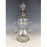 A Victorian silver mounted free blown glass decanter, of waisted and subtly faceted form with a pair