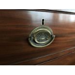 [Napoleonic Wars] An early 19th Century bow-fronted mahogany chest of drawers, bearing stamped brass