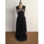 A 1940s black moire evening dress, having broad gathered straps above a panelled bodice with