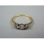 A vintage three stone diamond ring, in a graded arrangement, with central brilliant cut stone of