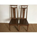 A pair of early 20th Century Arts and Crafts inlaid oak standard chairs