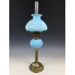 A Victorian brass oil lamp, with spirally reeded column and gadrooned base, with conforming