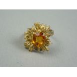 A vintage topaz and 9ct gold cocktail ring, the faceted oval stone claw set to the centre of a