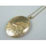 A large 9ct gold double locket, on a yellow metal fancy link neck chain, latter stamped '9ct', 25.