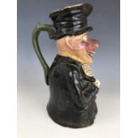 A late 19th Century earthenware whisky character jug, modelled in the form of a jolly drunken