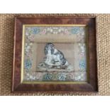 A Victorian woolwork gros point embroidery of a spaniel seated on a footstool, in a running floral