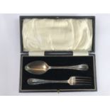 A George V cased silver reed and ribbon pattern Christening fork and spoon set, A. Wilcox,