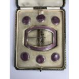 An early George V silver and mauve guilloche enamelled buckle and button set, presented in