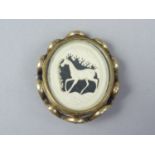 A Victorian double locket pivoting brooch, containing a carved bone vignette of a prancing horse,