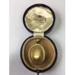 A Victorian yellow metal double locket, each oval face subtly convex and framed by a reeded and