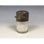 A George V silver mounted cut glass smelling salts bottle, with hinged cover, parcel gilt interior